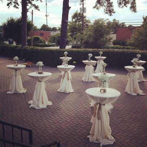 Outdoor Cocktail Tables With Tulle Overlays Burlap Ties And Baby S Breath Centerpieces Atop A