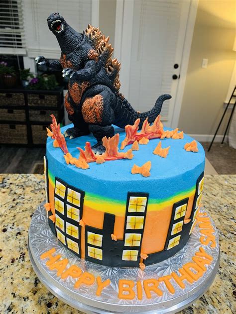 A Birthday Cake With A Godzilla On Top