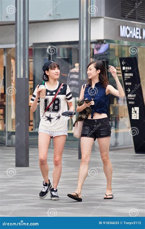 Fashionable Girls Walk In The Village Shopping Area Beijing China