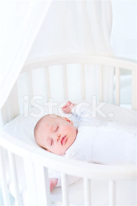 Little Newborn Baby Boy Sleeping In Round Crib With Canopy Stock Photo