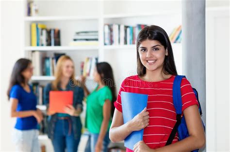 Laughing Hispanic Female Student With Group Of Multi Ethnic College