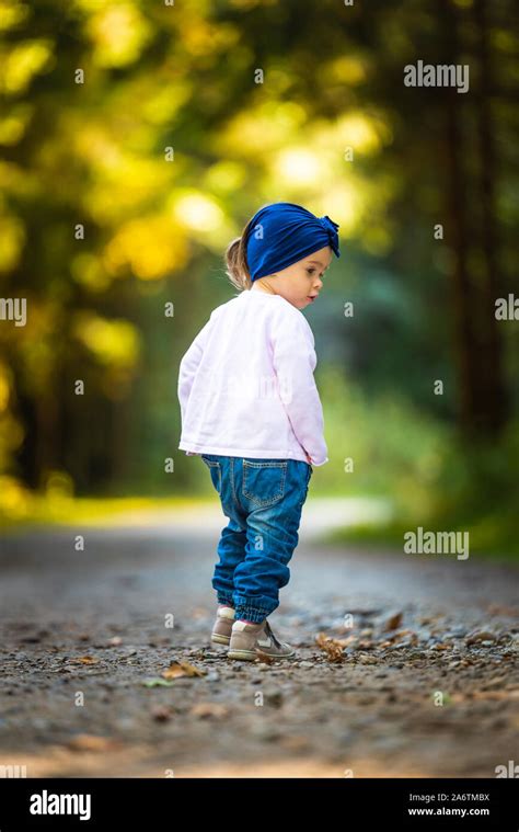 Portrait Of 2 Years Old Baby Girl In Forest Walking By Herself Not