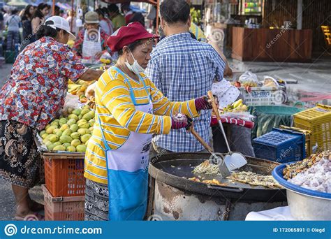 thai street vendor woman prepares and sells food on the traditional street market at island koh