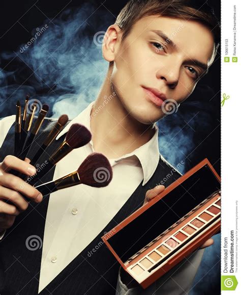 Professional Makeup Artist Posing In Studio Holds A Palette Of Stock
