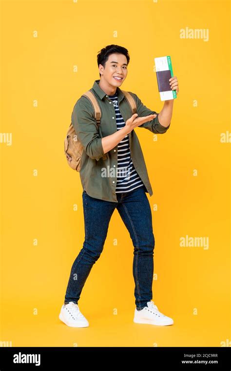 Full Length Portrait Of Excited Young Asian Backpacker Tourist Man With