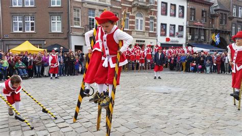 Some People In Red And White Outfits Are Performing On Stils