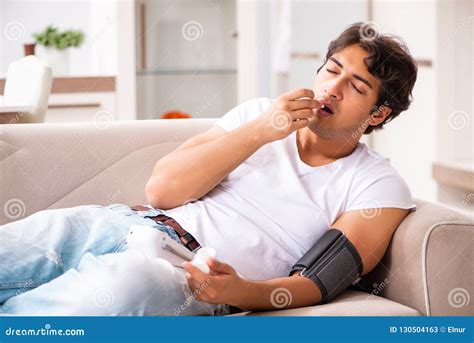 The Young Man Measuring Blood Pressure At Home Stock Image Image Of