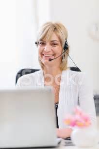 Smiling Senior Business Woman With Headset Working On Laptop Stock Photo Royalty Free Freeimages
