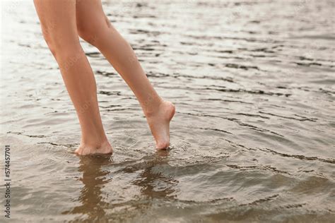 Close Up Naked Slim Woman Legs Walking Barefoot Along The River Female Feet On Sea Beach With