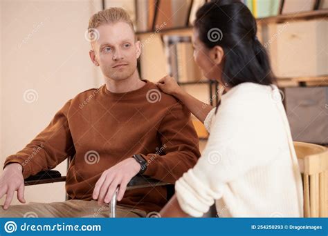 Caregiver Supporting Man In Wheelchair Stock Image Image Of Positive