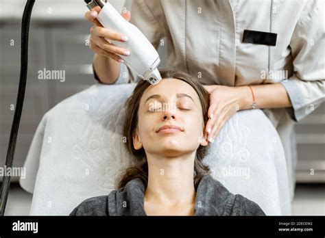 Portrait Of A Young Woman During A Facial Rejuvenation Treatment At