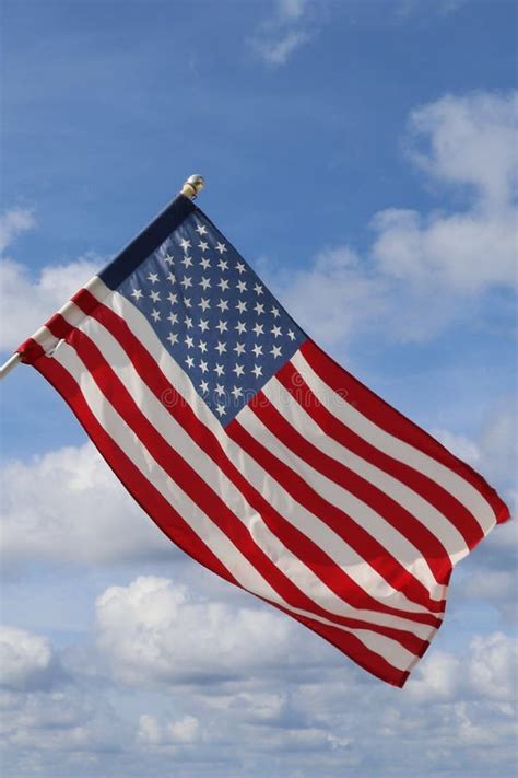 Waving Usa Flag In Blue And Cloudy Sky American Symbol Of Fourth Of