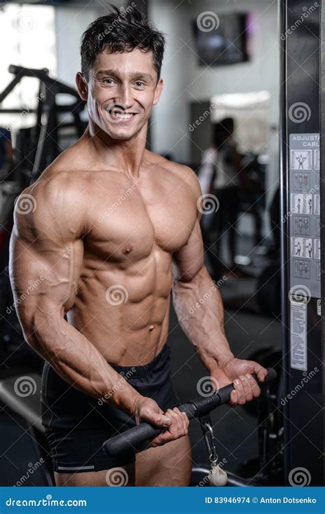 Handsome Bodybuilder Training In The Gym Man Lift Dumbbells Stock Photo