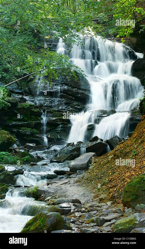 Beautiful Streaming Water Waterfall Landscape On Rocks In Green Forest