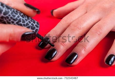 In an unrelated incident, he. Young Women Applying Black Nail Polish Stock Photo (Edit ...