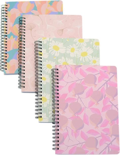 Five Spiral Notebooks With Different Designs On Each One All Lined Up
