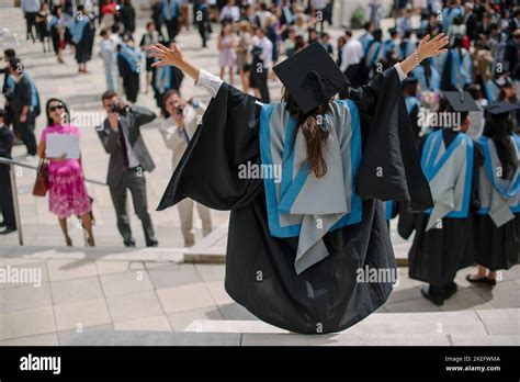 A University Student At Graduation In Cap And Gown Celebrating Passing