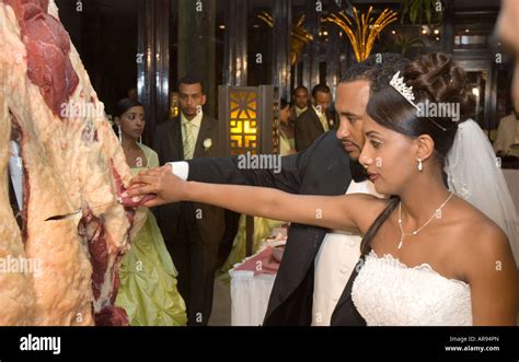 Ethiopian Bride And Groom Carving From A Side Of Raw Beef At A Wedding
