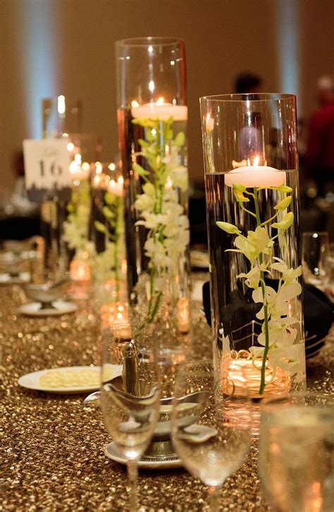 Rustic fall table setting ideas for outdoor celebrations. An elegant floating candle table centerpiece creates a ...