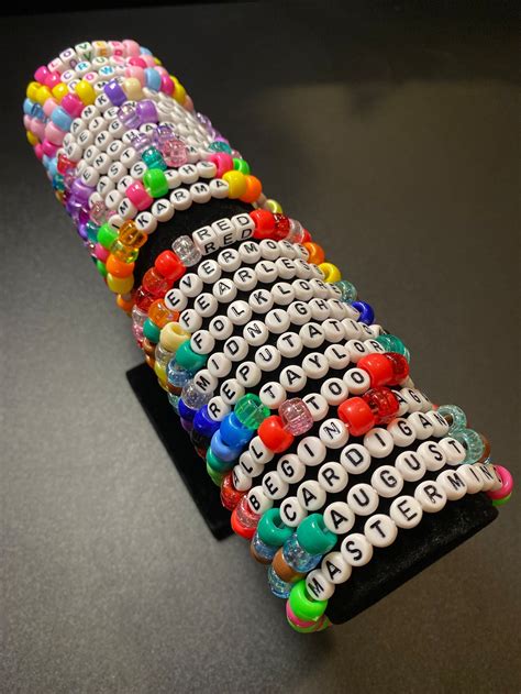 A Bunch Of Bracelets Sitting On Top Of A Black Table Next To Each Other