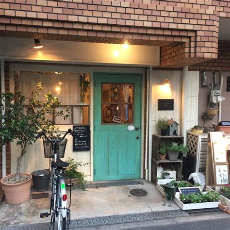 A Bicycle Is Parked In Front Of A Building With Plants And Potted