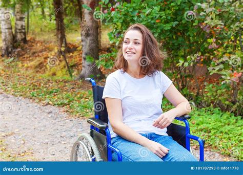 Young Happy Handicap Woman In Wheelchair On Road In Hospital Park