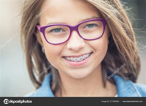Portrait Of Happy Young Girl With Dental Braces And Glasses Stock Photo