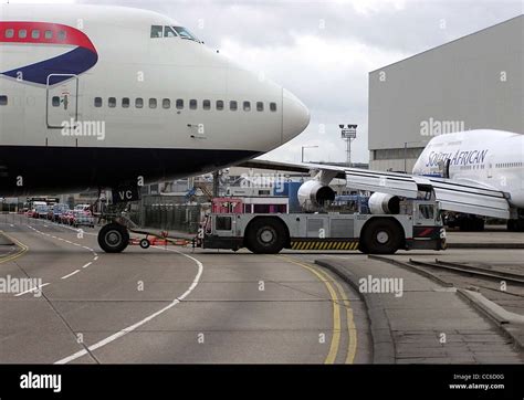 A Ground Handling Tug Pulls A British Airways Boeing 747 400 G Civc