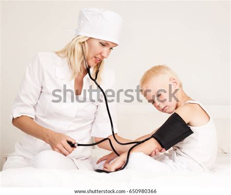 Doctor Examining Childs Blood Pressure Bed Stock Photo 650980366