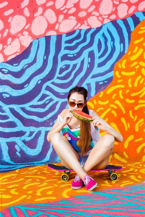 hip urban skate girl enjoy in watermelon during hot day by stocksy contributor audshule