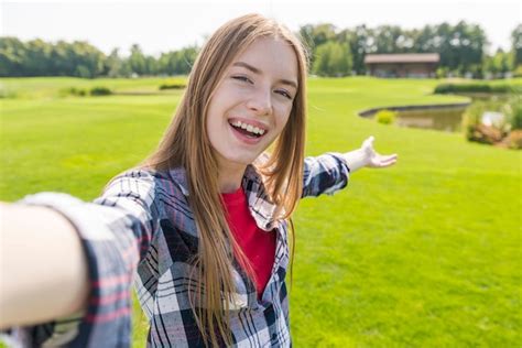 Free Photo Blonde Girl Taking A Selfie With A Beautiful Background
