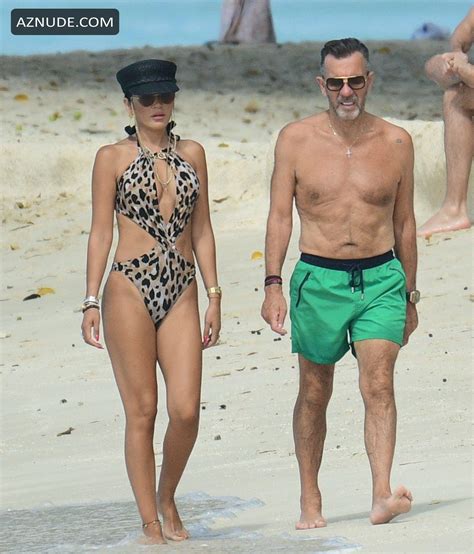 duncan bannatyne and his wife nigora bannatyne make a splash on the beach and have some fun in