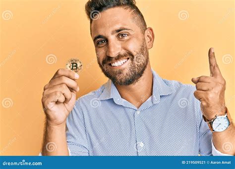 Handsome Man With Beard Holding Virtual Currency Bitcoin Surprised With
