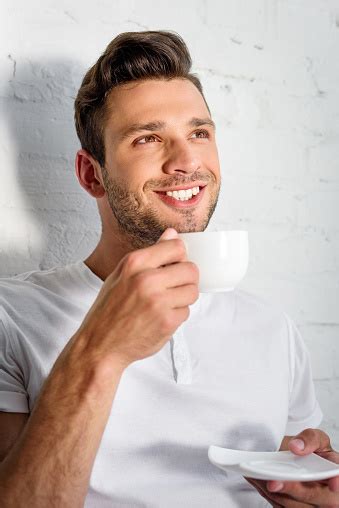 Handsome Smiling Young Man Drinking Coffee At Morning At Home Stock