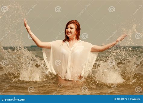 Redhead Woman Playing In Water During Summertime Stock Photo Image Of