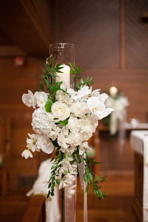 Anything and everything can become potential wedding décor item or prop. White Flower and Candle Wedding Altar Decor