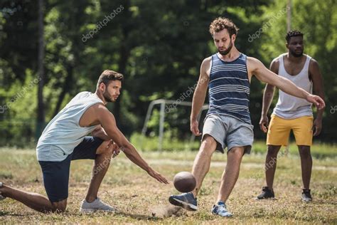 Multicultural Men Playing Football — Stock Photo © Arturverkhovetskiy