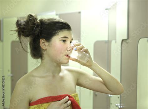 Teenager Girl With Towel And Water Glass After Shower Stock Photo