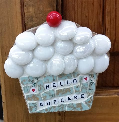 A Cupcake Made Out Of White Balloons With Words On It That Say Hello