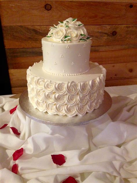 intimate wedding this 2 tier rose swirl bottom with triple pearl top and a bouquet of white