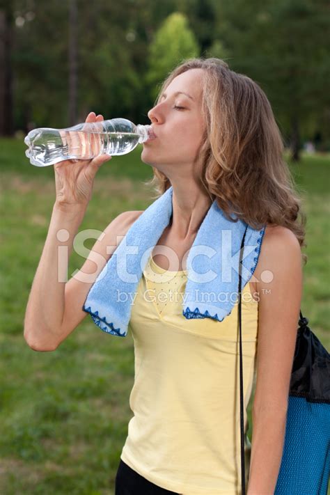 Portrait Of Young Woman Drinking Water After Outdoors Workout Stock