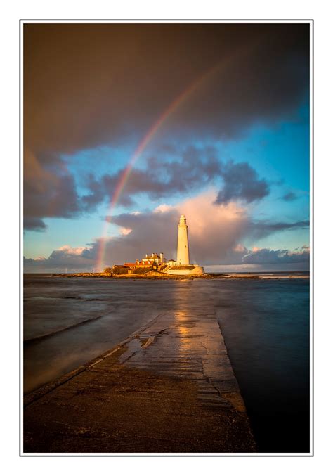 St Marys Lighthouse With Rainbow By Photographer Paul Compton