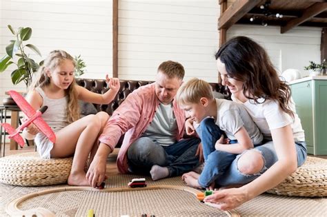 Parents Playing With Kids In Living Room Free Photo