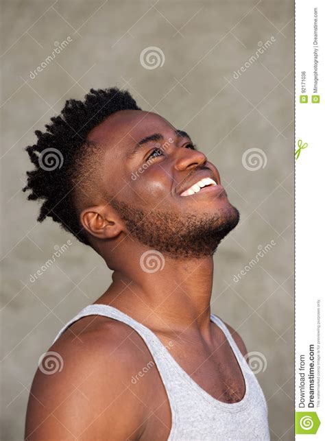 Happy Young Black Man Looking Up And Smiling Stock Photo Image Of
