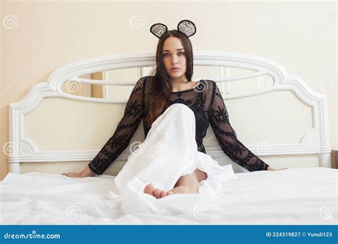 Beautiful Brunette Woman Lying In Bed Sensual Looking At Camera Seduction Concept In Luxury