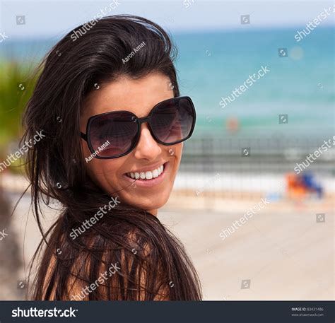 Woman Smiling Wearing Sunglasses In The Beach Stock Photo 83431486