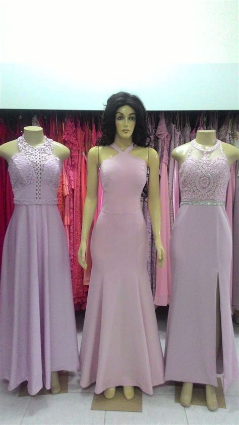 Three Mannequins Are Standing In Front Of Dresses