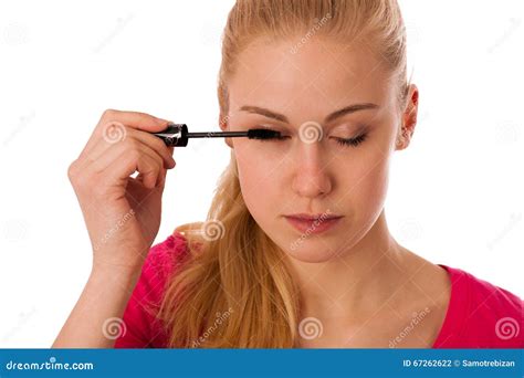 Woman Applying Black Mascara On Eyelashes Doing Makeup Stock Photo