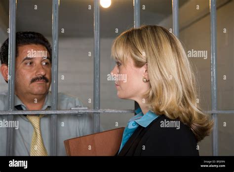 Lawyer with criminal behind bars in jail Stock Photo - Alamy