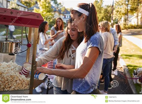 Girls Serve Themselves Popcorn At Neighbourhood Block